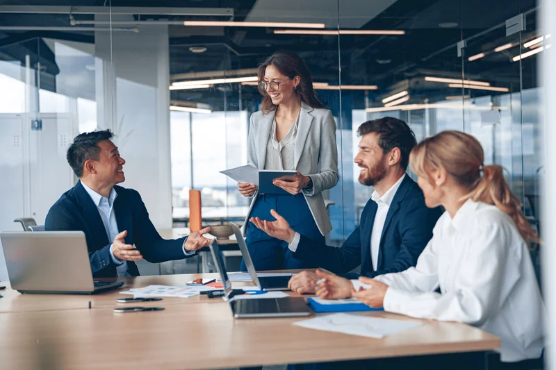 A diverse team of business leaders collaborating during a strategic management discussion in a modern office.