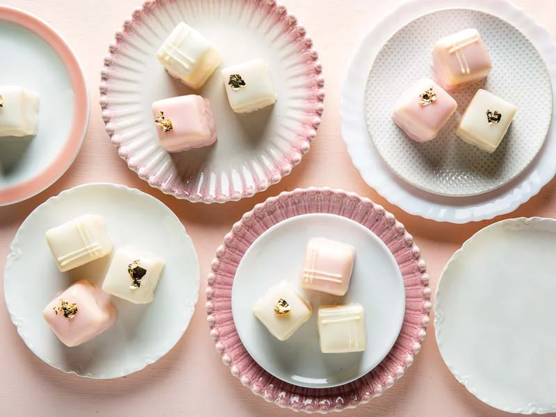 Petit Fours on Pink and White Plates on Pink Tablecloth