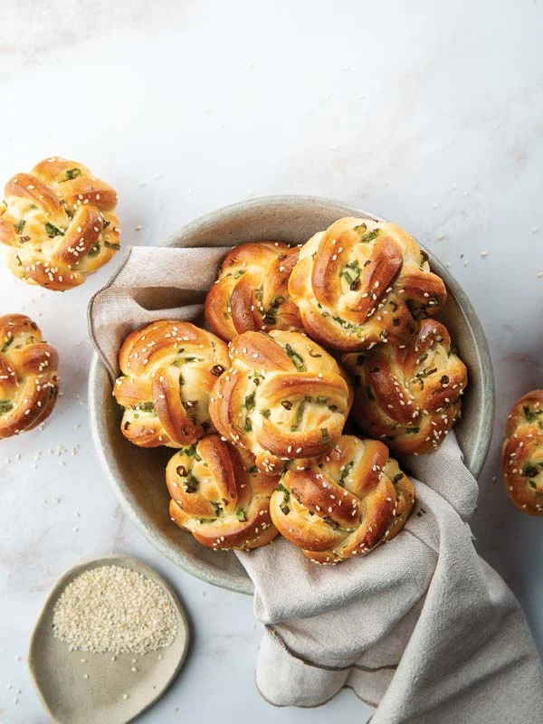 Green Onion Knots in Bowl with Towel on Marble